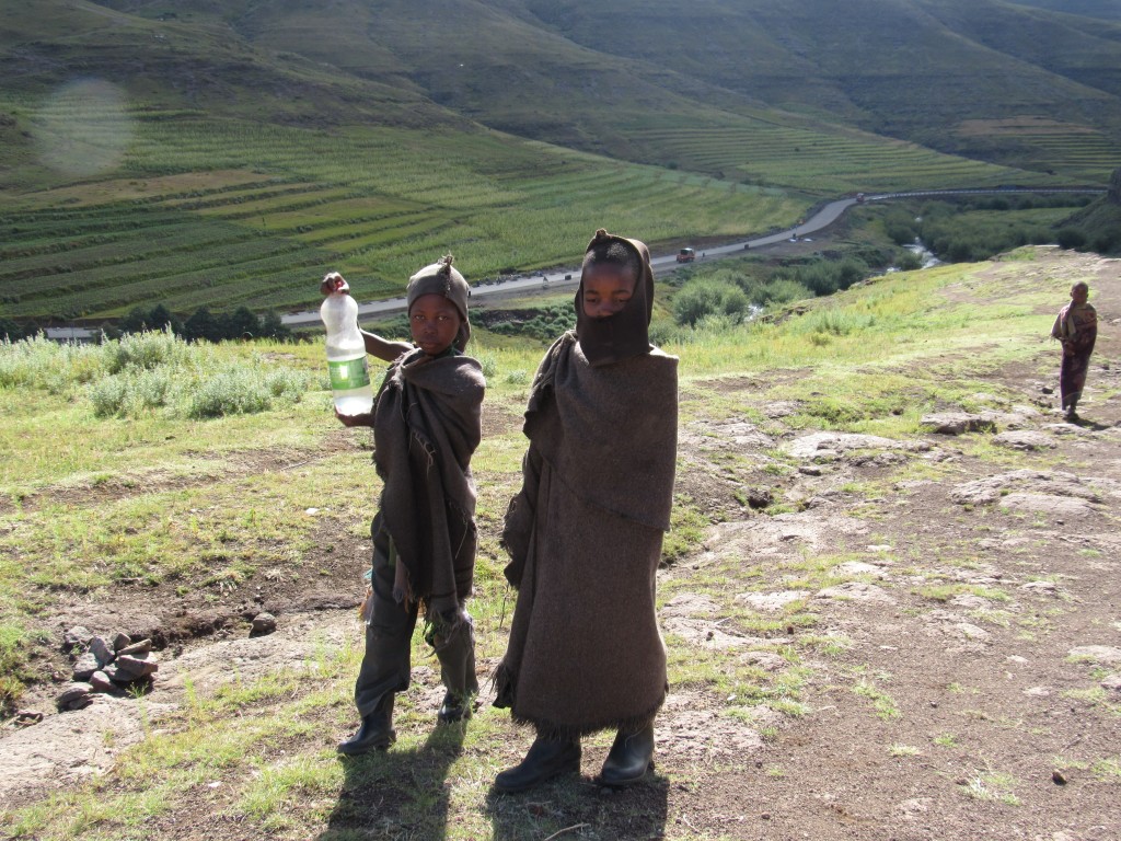 Young Basotho children with fresh spring water