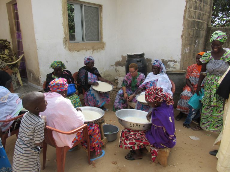 Senegalese ladies preparing meal at baby naming ceremony